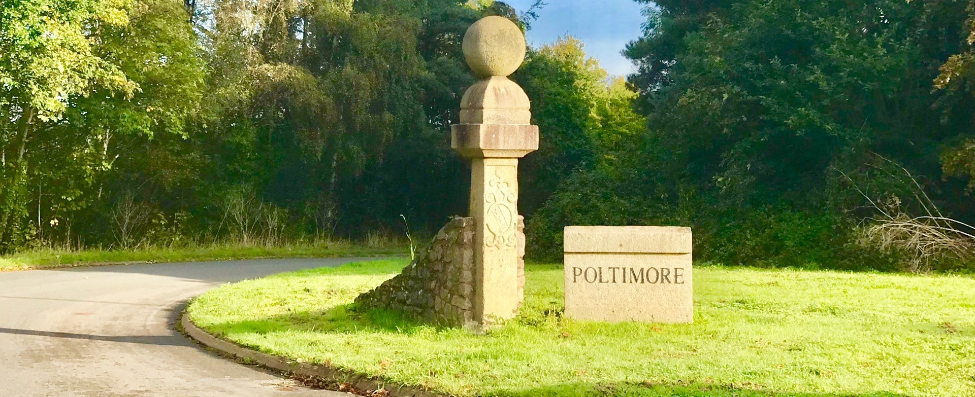 Entrance to Poltimore Village stone engraved sign