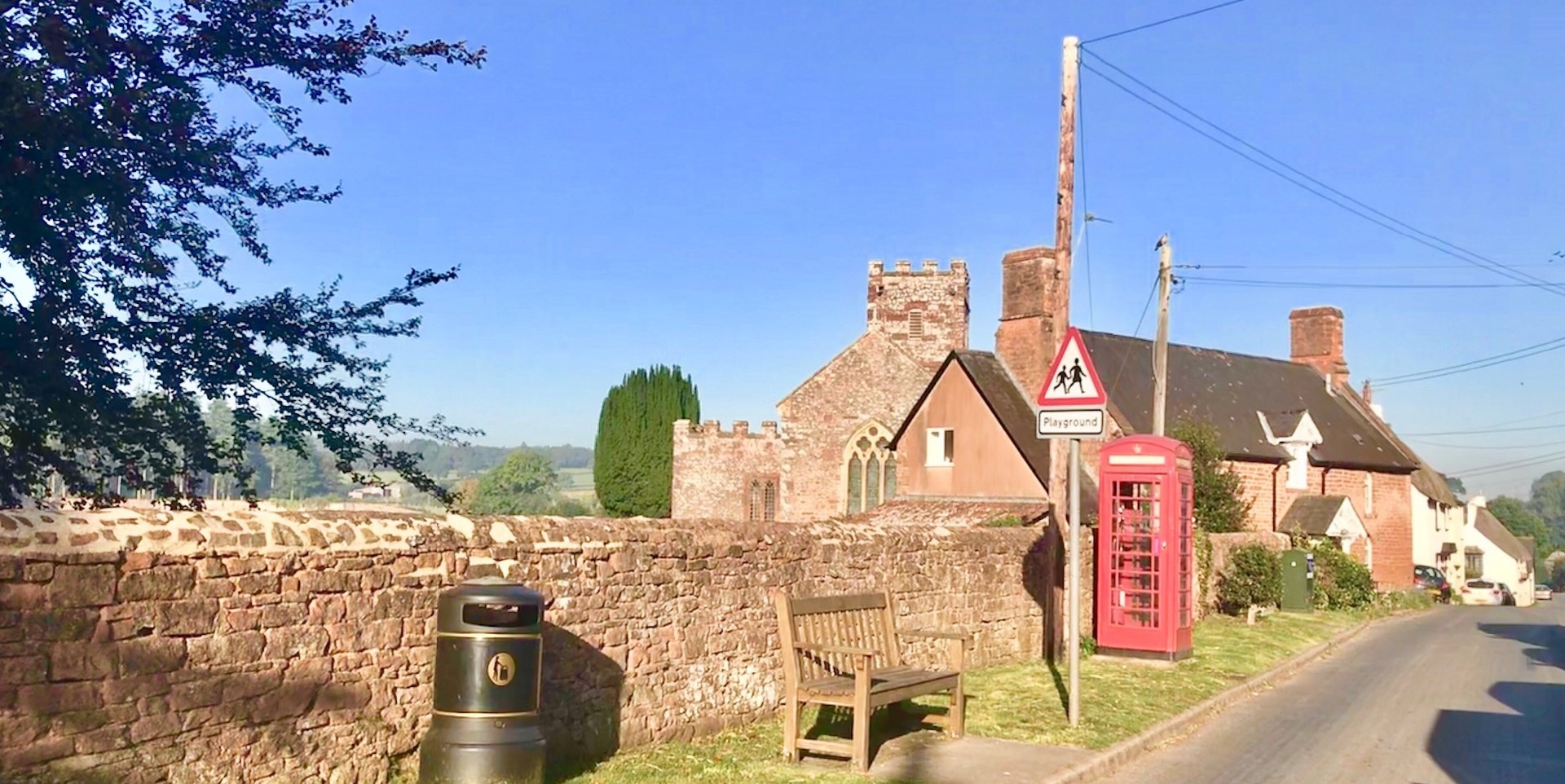 Poltimore Village showing the Church and Phone Box